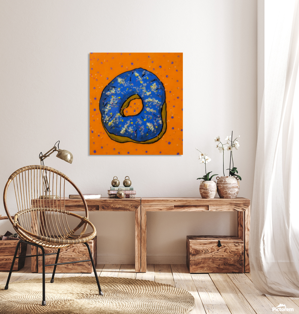 Bright colorful pop art print, in a home, featuring a whimsical blue donut with star glitter on a vibrant orange background.